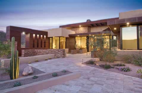 A stone tile driveway leading to a luxury custom home in Marana, AZ