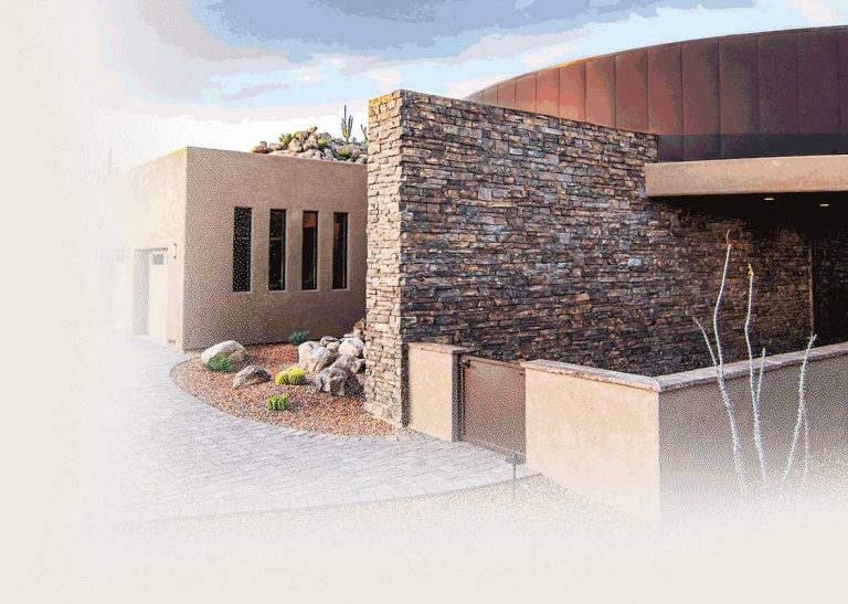 A stone wall detail outside of a luxury home in Stone Canyon