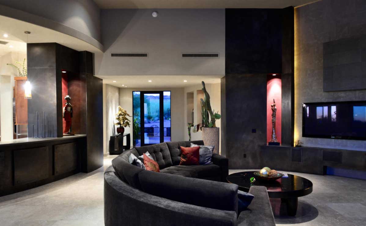 A custom living room with black walls and grey stone tiles