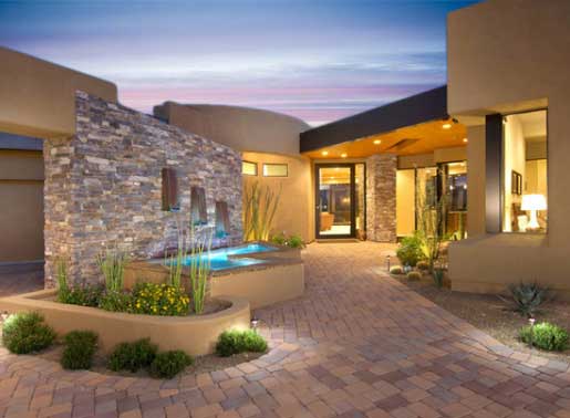 An Oro Valley luxury home with water features in the walkway leading to the entrance