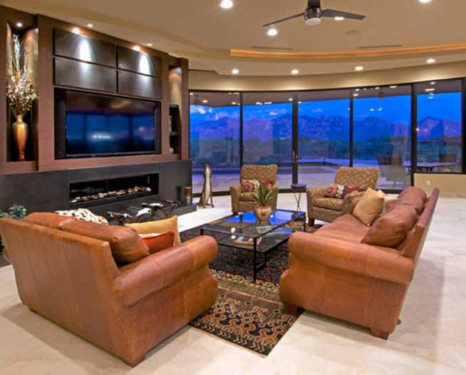 The living room of one of our custom homes which has large glass doors looking out to the backyard