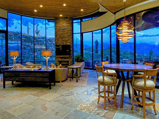 An open room in one of our Stone Canyon custom homes with large windows revealing a gorgeous view