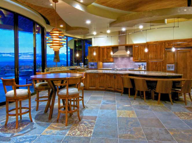 An open kitchen and dining room with wood cabinets in a house constructed by our Oro Valley custom home builders