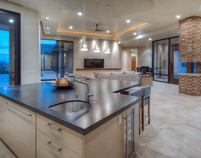 An open concept kitchen and living room in a house built by out Tucson custom home builders