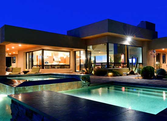 A contemporary custom home with an expansive inground pool