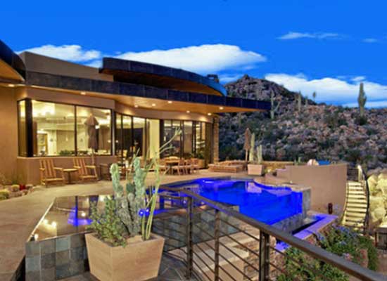 A Stone Canyon luxury home with an infinity edge swimming pool