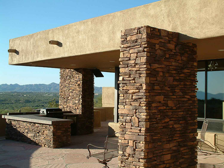 Stone columns and an outdoor kitchen in a custom home